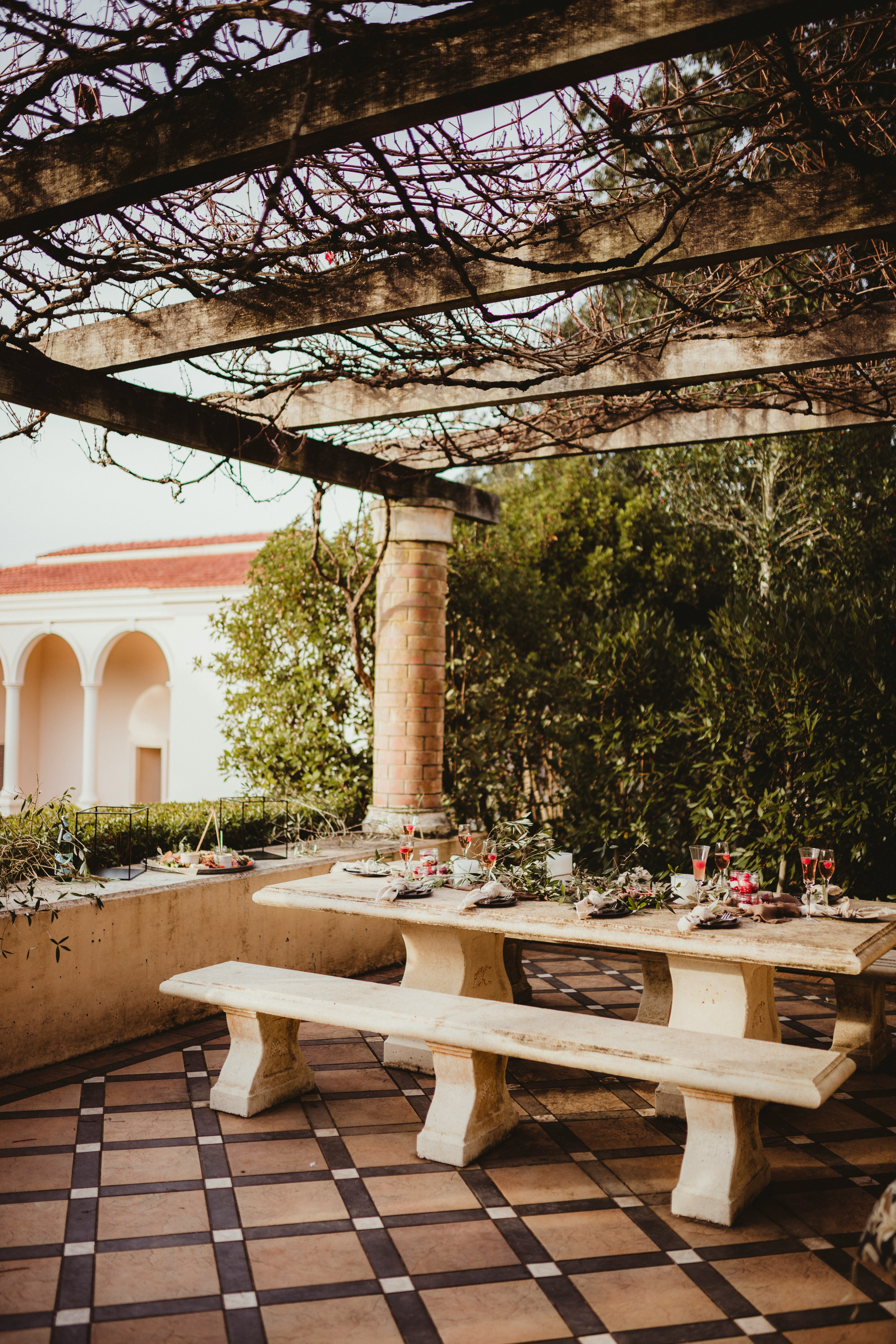 white wooden table and chairs near trees during daytime